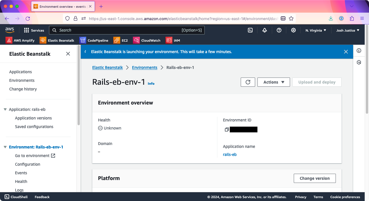 The 'Environment' page of Elastic Beanstalk, showing an environment named Rails-eb-env-1. A message says that Elastic Beanstalk is launching your environment.